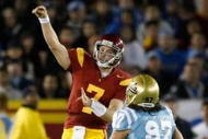 LOS ANGELES, CA - NOVEMBER 28:  Matt Barkley #7 of the USC Trojans throws the ball down field while being pursued by Damien Holmes #97 of the UCLA Bruins in the first half at the Los Angeles Memorial Coliseum on November 28, 2009 in Los Angeles, California.  USC defeated UCLA 28-7.  (Photo by Jeff Gross/Getty Images)