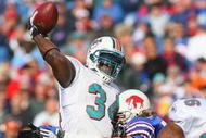 ORCHARD PARK, NY - NOVEMBER 29:  Ricky Williams #34 of the Miami Dolphins is hit by Paul Posluszny #51 of  the Buffalo Bills  as he throws a pass that is intercepted in the endzone at Ralph Wilson Stadium on November 29, 2009 in Orchard Park, New York. Buffalo won 31-14.  (Photo by Rick Stewart/Getty Images)