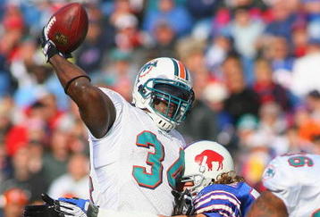 ORCHARD PARK, NY - NOVEMBER 29:  Ricky Williams #34 of the Miami Dolphins is hit by Paul Posluszny #51 of  the Buffalo Bills  as he throws a pass that is intercepted in the endzone at Ralph Wilson Stadium on November 29, 2009 in Orchard Park, New York. Buffalo won 31-14.  (Photo by Rick Stewart/Getty Images)