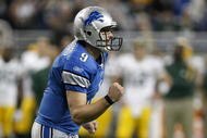 DETROIT , MI - NOVEMBER 26:  Matthew Stafford #9 of the Detroit Lions reacts after throwing a first quarter touchdown while playing the Green Bay Packers on November 26, 2009 at Ford Field in Detroit, Michigan.  (Photo by Gregory Shamus/Getty Images)