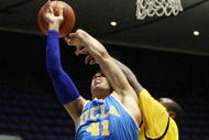 ANAHEIM, CA - NOVEMBER 29: Larry Anderson #21 of Long Beach State fouls Niko Dragovic #41 of UCLA on a block attempt in the second half during the 76 Classic at Anaheim Convention Center on November 29, 2009 in Anaheim, California. Long Beach State defeated UCLA 79-68. (Photo by Victor Decolongon/Getty Images)