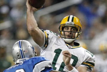 DETROIT , MI - NOVEMBER 26:  Aaron Rodgers #12 of the Green Bay Packers throws a third quarter touchdown behind Kevin Hobbs #23 of the Detroit Lions on November 26, 2009 at Ford Field in Detroit, Michigan. Green Bay won the game 34-12. (Photo by Gregory Shamus/Getty Images)