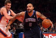 NEW YORK - NOVEMBER 09: Carlos Boozer #5 of the Utah Jazz drives to the basket past David Lee #42 of the New York Knicks at Madison Square Garden on November 9, 2009 in New York City.  NOTE TO USER: User expressly acknowledges and agrees that, by downloading and/or using this Photograph, User is consenting to the terms and conditions of the Getty Images License Agreement.  (Photo by Nick Laham/Getty Images)