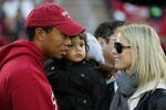 PALO ALTO, CA - NOVEMBER 21:  Honorary Standford Cardinal captain Tiger Woods holds his daugher, Sam, and speaks to his wife, Elin Nordegren, on the sidelines before the Cardinal game against the California Bears at Stanford Stadium on November 21, 2009 in Palo Alto, California.  (Photo by Ezra Shaw/Getty Images)