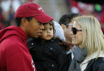 PALO ALTO, CA - NOVEMBER 21:  Honorary Standford Cardinal captain Tiger Woods holds his daugher, Sam, and speaks to his wife, Elin Nordegren, on the sidelines before the Cardinal game against the California Bears at Stanford Stadium on November 21, 2009 in Palo Alto, California.  (Photo by Ezra Shaw/Getty Images)