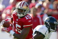 SAN FRANCISCO - NOVEMBER 29:  Michael Crabtree #15 of the San Francisco 49ers runs with the ball after making a reception during their game against the Jacksonville Jaguars at Candlestick Park on November 29, 2009 in San Francisco, California.  (Photo by Ezra Shaw/Getty Images)