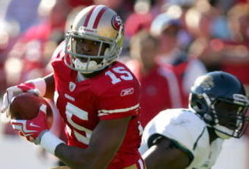 SAN FRANCISCO - NOVEMBER 29:  Michael Crabtree #15 of the San Francisco 49ers runs with the ball after making a reception during their game against the Jacksonville Jaguars at Candlestick Park on November 29, 2009 in San Francisco, California.  (Photo by Ezra Shaw/Getty Images)