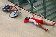 PRUSZKOW, POLAND - MARCH 25:  Edyta Jasinska of Poland on the floor after crashing during the Women's Individual pursuit qualifying during the UCI Track Cycling World Championships at the BGZ Arena on March 25, 2009 in Pruszkow, Poland.  (Photo by Clive Rose/Getty Images)