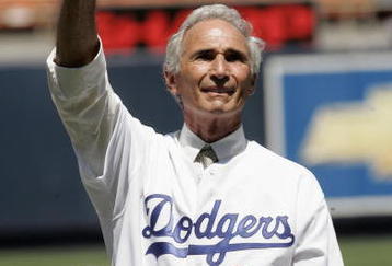 LOS ANGELES - AUGUST 28: Hall of Fame pitcher Sandy Koufax of the Los Angeles Dodgers waves to the crowd during ceremonies honoring memebers of the 1955 World Champion Dodgers before the game with the Houston Astros on August 28, 2005 at Dodger Stadium in Los Angeles, California. The Dodgers won 1-0. (Photo by Stephen Dunn /Getty Images)