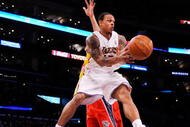 LOS ANGELES, CA - NOVEMBER 29:  Shannon Brown #12 of the Los Angeles Lakers paasses the ball under pressure form Devin Harris #34 of the New Jersey Nets during the second quarter of the NBA basketball game at Staples Center on November 29, 2009 in Los Angeles, California. NOTE TO USER: User expressly acknowledges and agrees that, by downloading and/or using this Photograph, user is consenting to the terms and conditions of the Getty Images License Agreement.  (Photo by Kevork Djansezian/Getty Images)