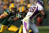 GREEN BAY, WI - NOVEMBER 11: Adrian Peterson #28 of the Minnesota Vikings fumbles the ball as he is hit by Atari Bigby #20 of the Green Bay Packers as Brady Popponga #51 also defends on November 11, 2007 at Lambeau Field in Green Bay, Wisconsin. The Packers defeated the Vikings 34-0. (Photo by Jonathan Daniel/Getty Images)