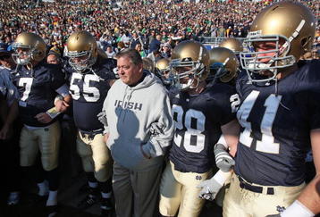 SOUTH BEND, IN - NOVEMBER 21: Head coach Charlie Weis of the Notre Dame Fighting Irish waits to enter the field with (L-R) Jimmy Clausen #7, Eric Olsen #55, Kyle McCarthy #28 and Scott Smith #41 before a game against the University of Connecticut Huskies at Notre Dame Stadium on November 21, 2009 in South Bend, Indiana. (Photo by Jonathan Daniel/Getty Images)