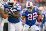 ORCHARD PARK, NY - NOVEMBER 29:  Fred Jackson #22 of the Buffalo Bills runs for his first  touchdown against  the Miami Dolphins behind a block by Corey McIntyre #38 at Ralph Wilson Stadium on November 29, 2009 in Orchard Park, New York. Buffalo won 31-14.  (Photo by Rick Stewart/Getty Images)