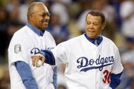 LOS ANGELES, CA - OCTOBER 07:  (R-L) Former Los Angeles Dodgers Maury Wills and Tommy Davis throw out the first pitch before the Dodgers take on the St. Louis Cardinals in Game One of the NLDS during the 2009 MLB Playoffs at Dodger Stadium on October 7, 2009 in Los Angeles, California.  (Photo by Jeff Gross/Getty Images)