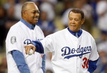 LOS ANGELES, CA - OCTOBER 07:  (R-L) Former Los Angeles Dodgers Maury Wills and Tommy Davis throw out the first pitch before the Dodgers take on the St. Louis Cardinals in Game One of the NLDS during the 2009 MLB Playoffs at Dodger Stadium on October 7, 2009 in Los Angeles, California.  (Photo by Jeff Gross/Getty Images)