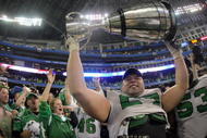 TORONTO - NOVEMBER 25:  Mike Abou-Mechrek #67 of the Saskatchewan Rough Riders hoists the Grey Cup in celebration of a 23-19 victory over the Winnipeg Blue Bombers during the 95th Grey Cup on November 25, 2007 at the Rogers Centre in Toronto, Ontario, Canada.  (Photo by Harry How/Getty Images)