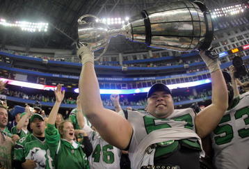TORONTO - NOVEMBER 25:  Mike Abou-Mechrek #67 of the Saskatchewan Rough Riders hoists the Grey Cup in celebration of a 23-19 victory over the Winnipeg Blue Bombers during the 95th Grey Cup on November 25, 2007 at the Rogers Centre in Toronto, Ontario, Canada.  (Photo by Harry How/Getty Images)