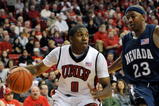 LAS VEGAS - NOVEMBER 18:  Oscar Bellfield #0 of the UNLV Rebels drives around Armon Johnson #23 of the Nevada Wolf Pack during their game at the Thomas & Mack Center on November 18, 2009 in Las Vegas, Nevada. UNLV won 88-75.  (Photo by Ethan Miller/Getty Images)