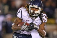 SOUTH BEND, IN - NOVEMBER 21: Andre Dixon #2 of the Univeristy of Connecticut Huskies runs for yardage in overtime against the Notre Dame Fighting Irish at Notre Dame Stadium on November 21, 2009 in South Bend, Indiana. Connecticut defeated Notre Dame 33-30 in overtime. (Photo by Jonathan Daniel/Getty Images)