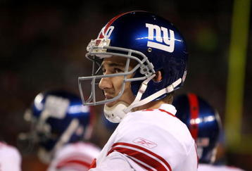 DENVER - NOVEMBER 26:  Quarterback Eli Manning #10 of the New York Giants looks on from the sidelines against the Denver Broncos during NFL action at Invesco Field at Mile High on November 26, 2009 in Denver, Colorado.  (Photo by Doug Pensinger/Getty Images)