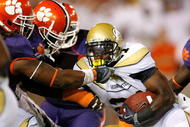 ATLANTA - SEPTEMBER 10: Da'Quan Bowers #93 and Brandon Thompson #98 of the Clemson Tigers tackle Jonathan Dwyer #21 of the Georgia Tech Yellow Jackets at Bobby Dodd Stadium on September 10, 2009 in Atlanta, Georgia. (Photo by Kevin C. Cox/Getty Images)