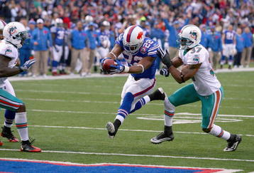 ORCHARD PARK, NY - NOVEMBER 29:  Fred Jackson #22 of the Buffalo Bills crosses the goal line for his second touchdown ahead of Yeremiah Bell #37 of the Miami Dolphins at Ralph Wilson Stadium on November 29, 2009 in Orchard Park, New York. Buffalo won 31-14. (Photo by Rick Stewart/Getty Images)