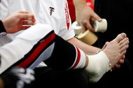 ATLANTA - NOVEMBER 29:  Quarterback Matt Ryan #2 of the Atlanta Falcons has his right foot attended to during the first half against the Tampa Bay Buccaneers at Georgia Dome on November 29, 2009 in Atlanta, Georgia.  (Photo by Kevin C. Cox/Getty Images)