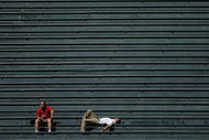 DENVER - SEPTEMBER 18:  Two fans in the vacant centerfield bleachers bask in the warm sun on a late summer afternoon as the Colorado Rockies host the Los Angeles Dodgers at Coors Field on September 18, 2007 in Denver, Colorado. The Rockies defeated the Dodgers 3-1 in the first game of a double header.  (Photo by Doug Pensinger/Getty Images)