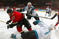 CALGARY, ALBERTA - MAY 16:  Curtis Brown #37 of the San Jose Sharks hits Dave Lowry #10 of the Calgary Flames during Game four of the 2004 NHL Western Conference Finals on May 16, 2004 at the Pengrowth Saddledome in Calgary, Alberta, Canda.  (Photo by Jeff Vinnick/Getty Images)
