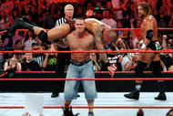 LAS VEGAS - AUGUST 24:  Wrestler John Cena picks up wrestler Randy Orton as wrestler Triple H (R) looks on during the WWE Monday Night Raw show at the Thomas & Mack Center August 24, 2009 in Las Vegas, Nevada.  (Photo by Ethan Miller/Getty Images)