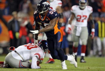 DENVER - NOVEMBER 26:  D.J. Williams #55 of the Denver Broncos reacts after sacking quarterback Eli Manning #10 of the New York Giants during NFL action at Invesco Field at Mile High on November 26, 2009 in Denver, Colorado. The Broncos defeated the Giants 26-6.  (Photo by Doug Pensinger/Getty Images)