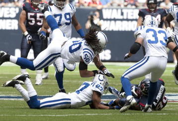 HOUSTON - NOVEMBER 29:  Wide receiver Andre Jophnson #80 of the Houston Texans is tackled by defensive back Jacob Lacey #27 and linebacker Philip Wheeler #50 of the Indianapolis Colts at Reliant Stadium on November 29, 2009 in Houston, Texas.  (Photo by Bob Levey/Getty Images)