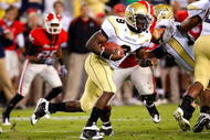 ATLANTA - NOVEMBER 28:  Quarterback Josh Nesbitt #9 of the Georgia Tech Yellow Jackets rushes upfield against the defense of the Georgia Bulldogs at Bobby Dodd Stadium on November 28, 2009 in Atlanta, Georgia.  (Photo by Kevin C. Cox/Getty Images)