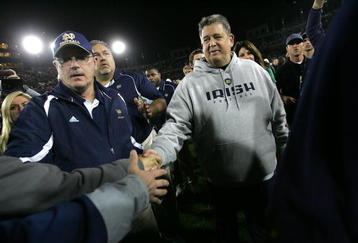 PALO ALTO, CA - NOVEMBER 28:  Notre Dame head coach Charlie Weis shakes hands with fans as he walks off the field after their loss to the Stanford Cardinal at Stanford Stadium on November 28, 2009 in Palo Alto, California.  (Photo by Ezra Shaw/Getty Images)