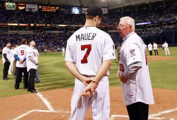MINNEAPOLIS, MN - OCTOBER 4: Former Minnesota Twins manager Tom Kelly talks with current player Joe Mauer during a tribute to the Hubert H. Humphrey Metrodome on October 4, 2009 in Minneapolis, Minnesota. The post-game ceremony marked the end of regular season baseball inside the Dome. (Photo by Genevieve Ross/Getty Images)