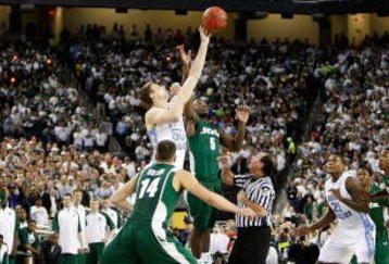 DETROIT - APRIL 06:  Travis Walton #5 of the Michigan State Spartans and Tyler Hansbrough #50 of the North Carolina Tar Heels go after a jump ball after the opening-tip had to be re-done during the 2009 NCAA Division I Men's Basketball National Championship game at Ford Field on April 6, 2009 in Detroit, Michigan.  (Photo by Streeter Lecka/Getty Images)