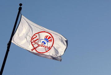 NEW YORK - APRIL 16: A Yankee flag waves over the new stadium during opening day between the New York Yankees and the Cleveland Indians at the new Yankee Stadium on April 16, 2009 in the Bronx borough of New York City. This is the first regular season MLB game being played at the new venue which replaced the old Yankee Stadium as the Yankees home field.  (Photo by Chris McGrath/Getty Images)