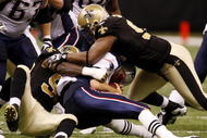 NEW ORLEANS - NOVEMBER 30: Tom Brady #12 of the New England Patriots is sacked in the second quarter of the game against the New Orleans Saints at Louisana Superdome on November 30, 2009 in New Orleans, Louisiana. (Photo by Chris Graythen/Getty Images)