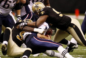 NEW ORLEANS - NOVEMBER 30: Tom Brady #12 of the New England Patriots is sacked in the second quarter of the game against the New Orleans Saints at Louisana Superdome on November 30, 2009 in New Orleans, Louisiana. (Photo by Chris Graythen/Getty Images)