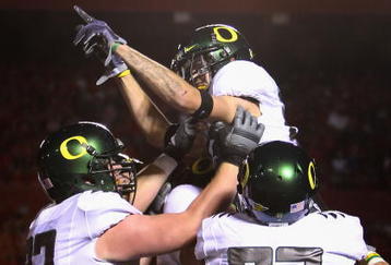 TUCSON, AZ - NOVEMBER 21:  Wide receiver Jeff Maehl #23 of the Oregon Ducks celebrates with teammates after scoring a second quarter touchdown against the Arizona Wildcats during the college football game at Arizona Stadium on November 21, 2009 in Tucson, Arizona.  The Ducks defeated the Wildcats 44-41 in second overtime.  (Photo by Christian Petersen/Getty Images)