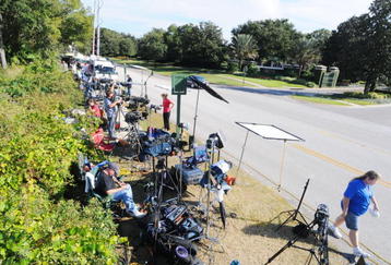 WINDERMERE, FL - NOVEMBER 30:   Media park outside of the Isleworth community, which is home to Tiger Woods, on November 30, 2009 in Windermere, Florida. Tiger Woods has not spoken with media or Florida Highway Patrol since he drove his SUV into a fire hydrant and tree outside his Florida home in the early hours of November 27.  (Photo by Gerardo Mora/Getty Images)