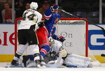 NEW YORK - NOVEMBER 30: Brooks Orpik #44 of the Pittsburgh Penguins propels Sean Avery #16 of the New York Rangers over goaltender Marc-Andre Fleury #29 at Madison Square Garden on November 30, 2009 in New York City.  (Photo by Bruce Bennett/Getty Images)