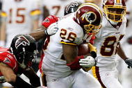 ATLANTA - NOVEMBER 08:  Clinton Portis #26 of the Washington Redskins rushes upfield against Thomas DeCoud #28 of the Atlanta Falcons at Georgia Dome on November 8, 2009 in Atlanta, Georgia.  (Photo by Kevin C. Cox/Getty Images)