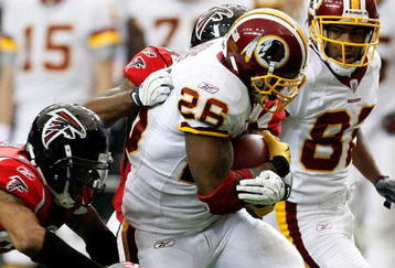 ATLANTA - NOVEMBER 08:  Clinton Portis #26 of the Washington Redskins rushes upfield against Thomas DeCoud #28 of the Atlanta Falcons at Georgia Dome on November 8, 2009 in Atlanta, Georgia.  (Photo by Kevin C. Cox/Getty Images)