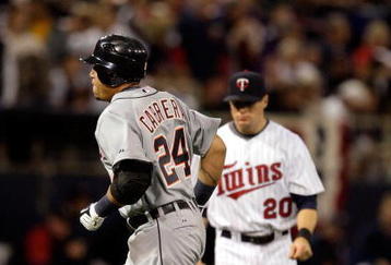 MINNEAPOLIS - OCTOBER 06:  Miguel Cabrera #24 of the Detroit Tigers rounds the bases after hitting a home run as Matt Tolbert #20 of the Minnesota Twins looks on during the 3rd inning of the American League Tiebreaker game on October 6, 2009 at Hubert H. Humphrey Metrodome in Minneapolis, Minnesota.  (Photo by Jamie Squire/Getty Images)