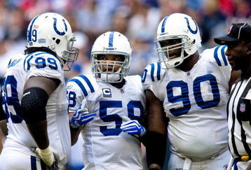 HOUSTON - NOVEMBER 29: Defensive tackles Antonio Johnson #99 and Daniel Muir #90 chat with linebacker Ramon Humber #59 of the Indianapolis Colts chat during a time out against the Houston Texans at Reliant Stadium on November 29, 2009 in Houston, Texas.  (Photo by Bob Levey/Getty Images)