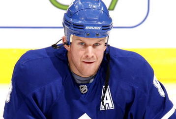 TORONTO - NOVEMBER 30:  Mike Komisarek #8 of the Toronto Maple Leafs stretches during warmup before playing the Buffalo Sabres November 30, 2009 at the Air Canada Centre in Toronto, Ontario, Canada. (Photo by Abelimages / Getty Images)