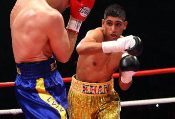 MANCHESTER, ENGLAND - JULY 18:  Amir Khan throws a right cross on his way to beating  Andreas Kotelnik to become the new WBA Light Welterweight Champion  on July 18, 2009  at the MEN Arena in Manchester, England.  (Photo by John Gichigi/Getty Images)