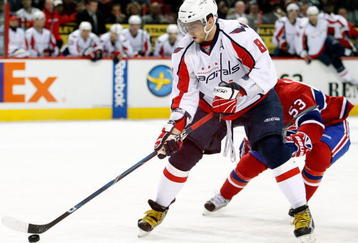 MONTREAL- NOVEMBER 28:  Alex Ovechkin #8 of the Washington Capitals skates with the puck while being defended by Ryan White #53 of the Montreal Canadiens during the NHL game on November 28, 2009 at the Bell Centre in Montreal, Quebec, Canada.  The Capitals defeated the Canadiens 4-3 in a shootout.  (Photo by Richard Wolowicz/Getty Images)