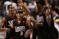 TORONTO - NOVEMBER 8:  (L-R) Kevin Ollie #12, Allen Iverson #3 and Samuel Dalembert #1 of the Philadelphia 76ers share a laugh during the game against the Toronto Raptors  on November 8, 2006 at the Air Canada Centre in Toronto, Canada. The Raptors defeated the Sixers 106-104. NOTE TO USER: User expressly acknowledges and agrees that, by downloading and or using this photograph, User is consenting to the terms and conditions of the Getty Images License Agreement.  (Photo by Harry How/Getty Images)